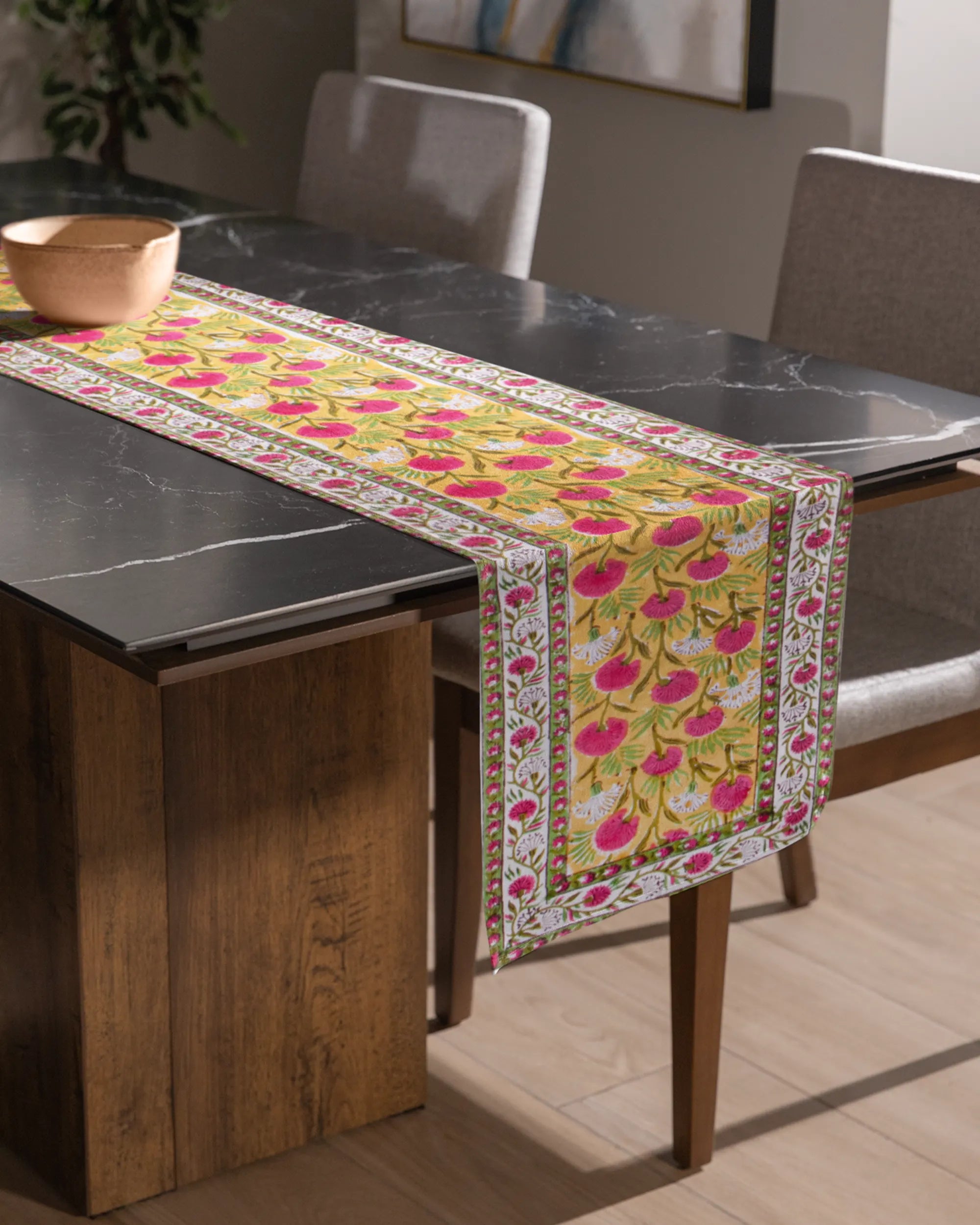 A beautiful yellow color table runner, with an elegant pink and white floral patterns. An essential table accessory that adds charm your home decor effortlessly.